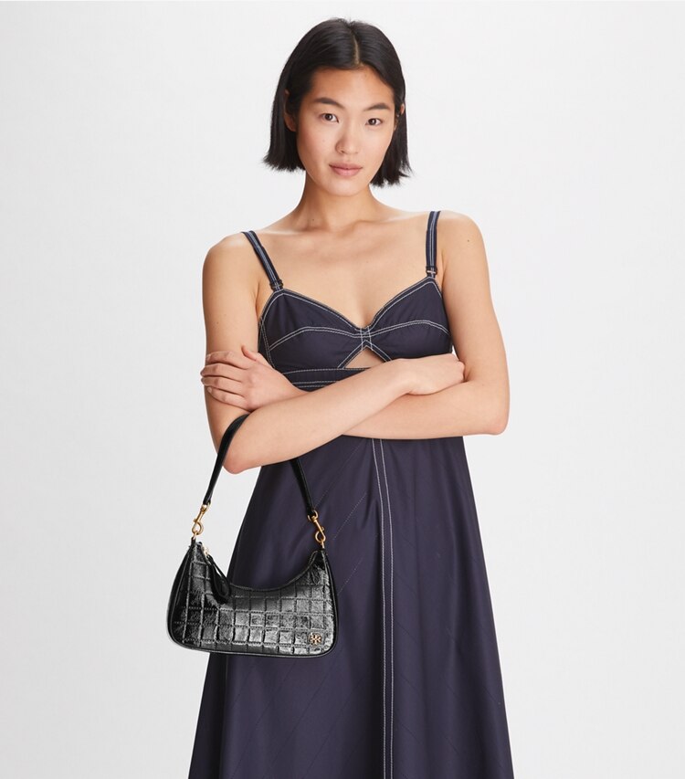 Tory Burch designer crossbody bags 151 Mercer Patent Quilt Small Crescent Bag in Black accessory on model