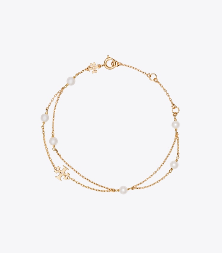 Tory Burch designer bracciali Bracciale Moondance effetto layering con perle in Tory Gold / Cream front