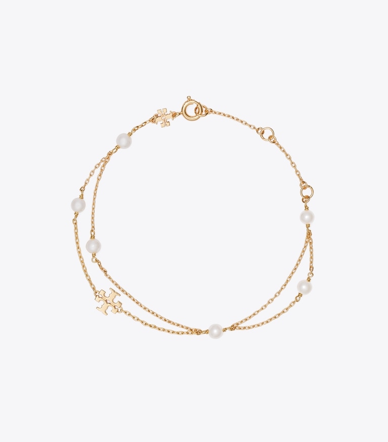 Tory Burch designer bracciali Bracciale Moondance effetto layering con perle in Tory Gold / Cream front