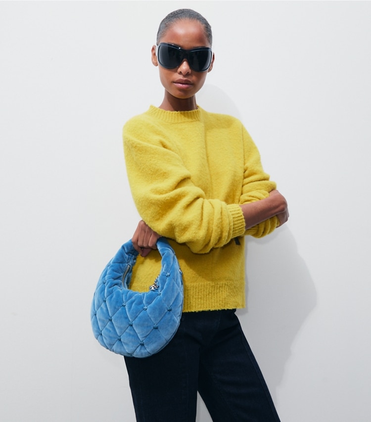 Tory Burch designer crossbody bags Bunny Knot Crescent Bag aus Samt in Steel Blue accessory on model