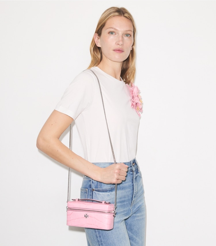 Tory Burch designer crossbody bags Charlie Croc-Embossed Vanity Case in Rose Sunset accessory on model
