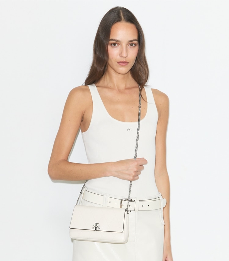 Tory Burch designer crossbody bags Charlie Quilted Chain Crossbody in Light Cream / Charms accessory on model