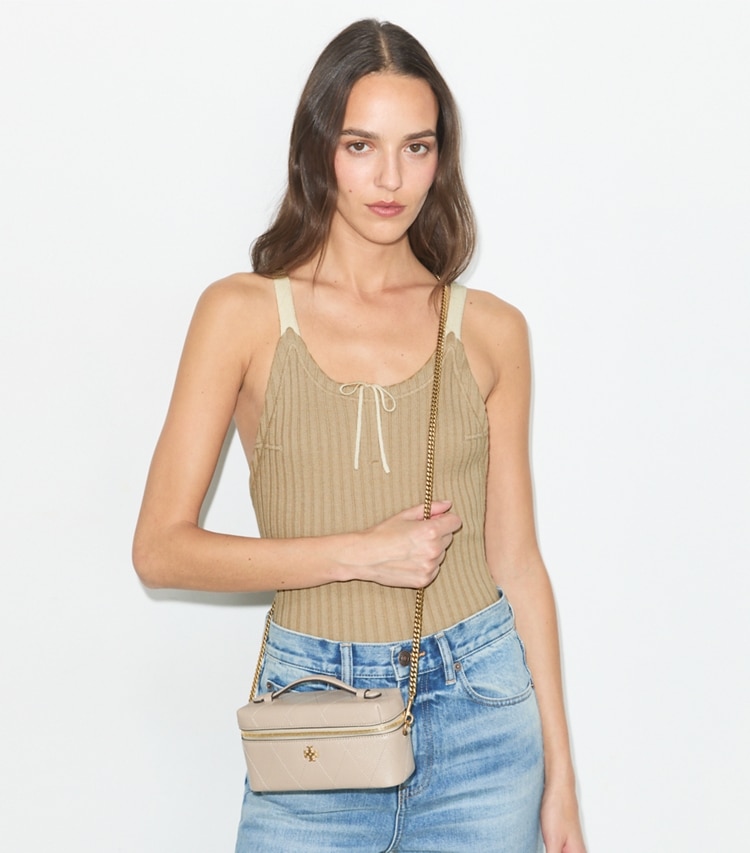 Tory Burch designer crossbody bags Charlie Quilted Vanity Case in Soft Cement accessory on model
