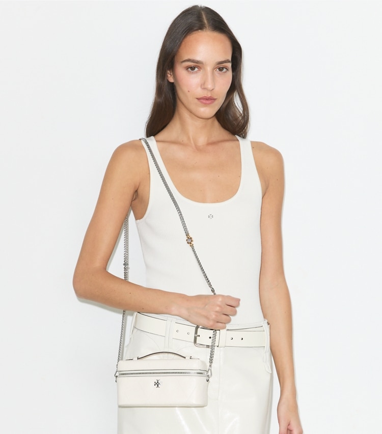Tory Burch designer crossbody bags Charlie Quilted Vanity Case in Light Cream / Charms accessory on model