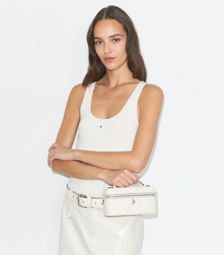 Tory Burch designer crossbody bags Charlie Quilted Vanity Case in Light Cream / Charms additional on model