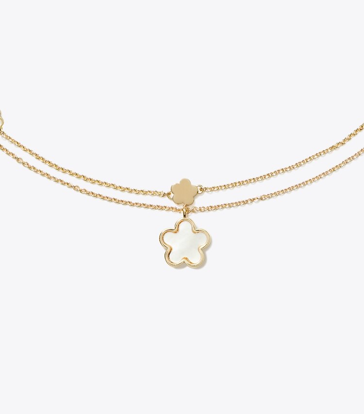Tory Burch designer collane Collana con ciondolo a fiore effetto layering in Tory Gold / Mother of Pearl dettaglio