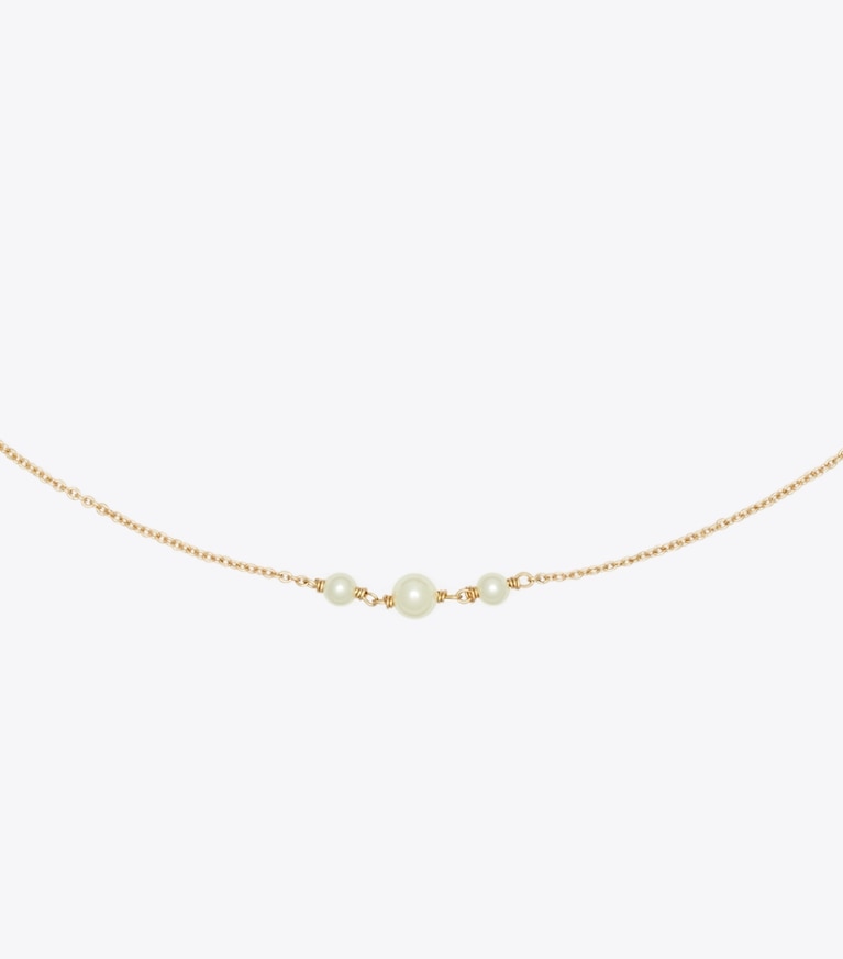 Tory Burch designer collane Collana sottile Moondance con perla e stella in Tory Gold / Crystal / Pearl dettaglio