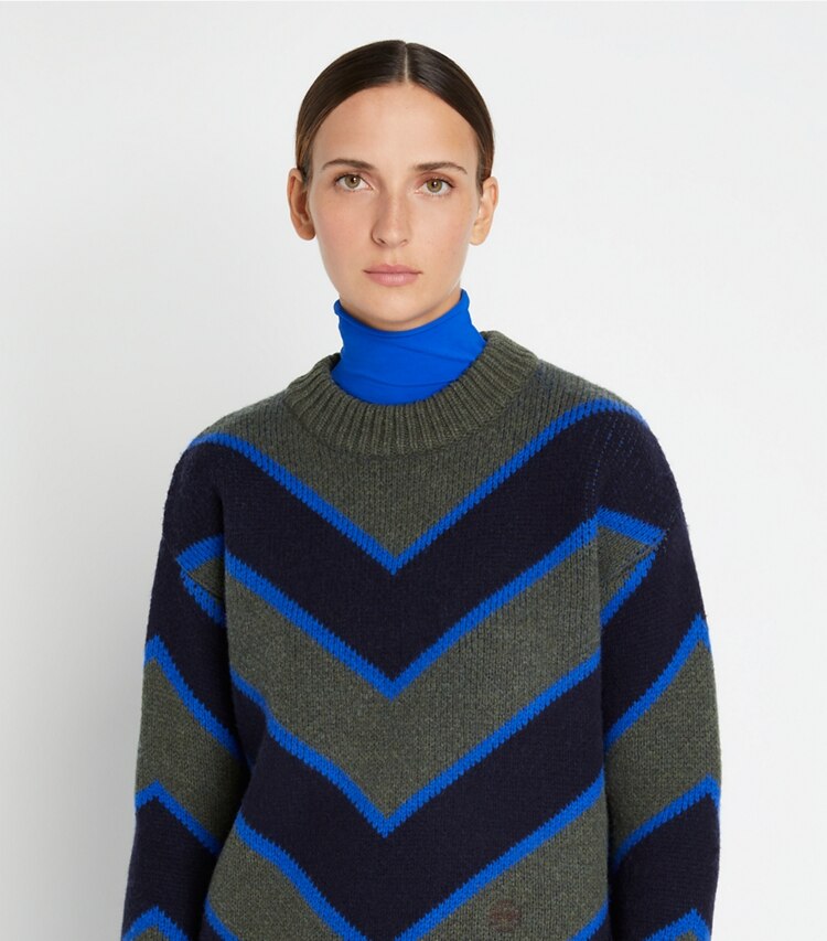 Tory Sport designer sweaters Colorblock Chevron Sweater in Light Olive / Tory Navy on model detail