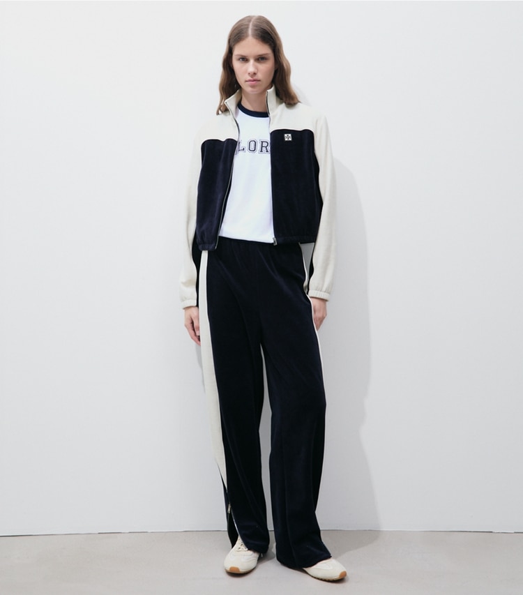 Tory Burch designer bottoms Colorblock Velour Sweatpant in Medium Navy / New Ivory on model front