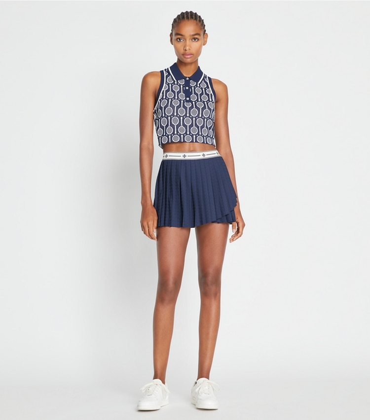 Tory Sport designer tops Cropped Tech Knit Polo Tank in Tory Navy Racquets on model front