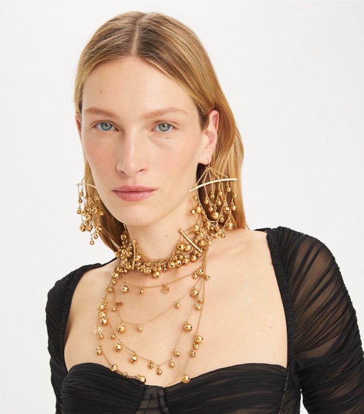 Tory Burch designer earrings Curiosity Bell Earrings in Antique Light Brass accessory on model