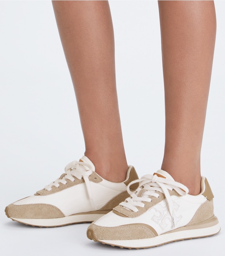 Tory Burch designer sneakers Destiny Trainer in WHITE / WHITE / AVOLA additional on model