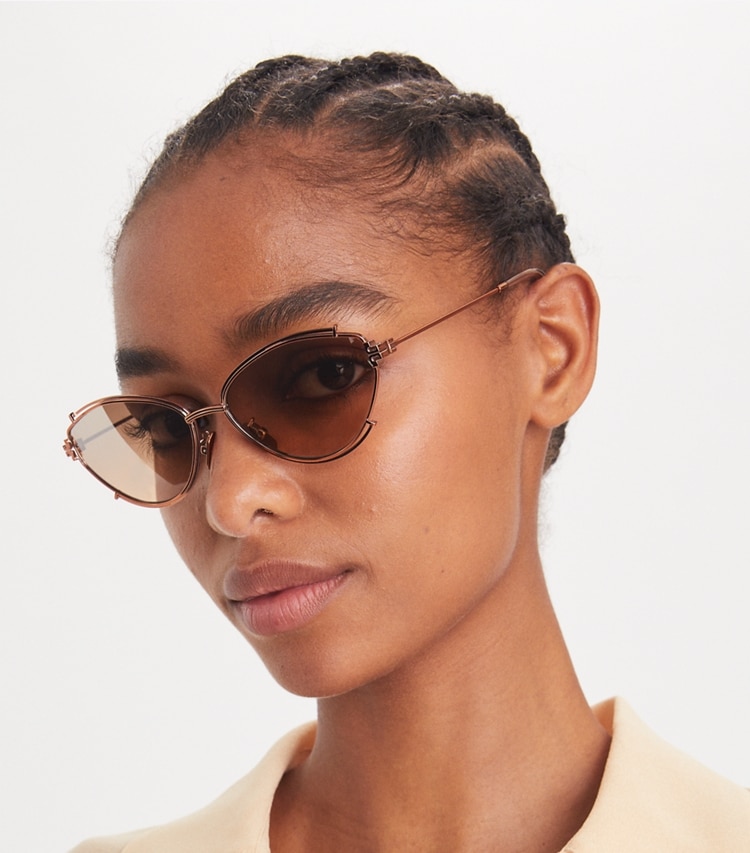 Tory Burch designer sunglasses & eyewear Eleanor Oval Sunglasses in COPPER/BROWN MIRROR GRADIENT SILVER accessory on model