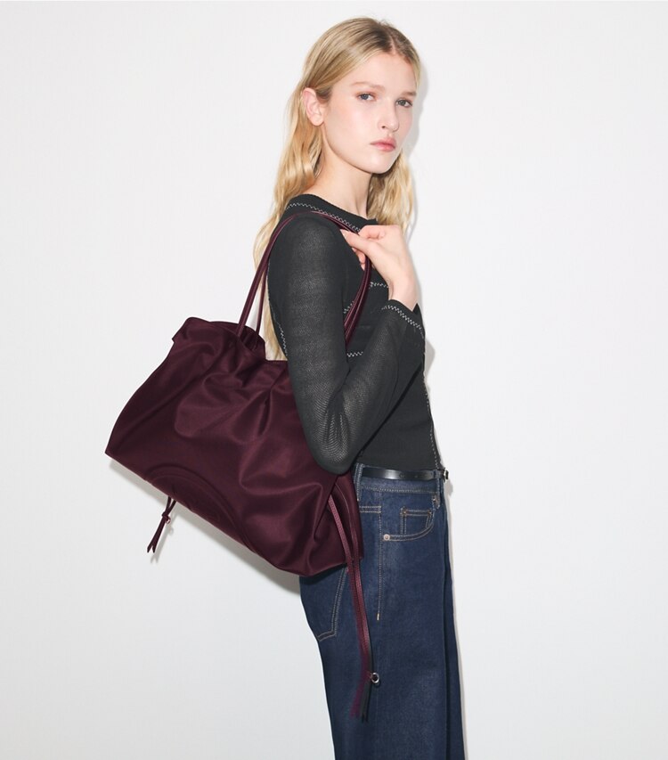 Tory Burch designer tote bags Ella Nylon Drawstring Tote in Dark Carmine accessory on model
