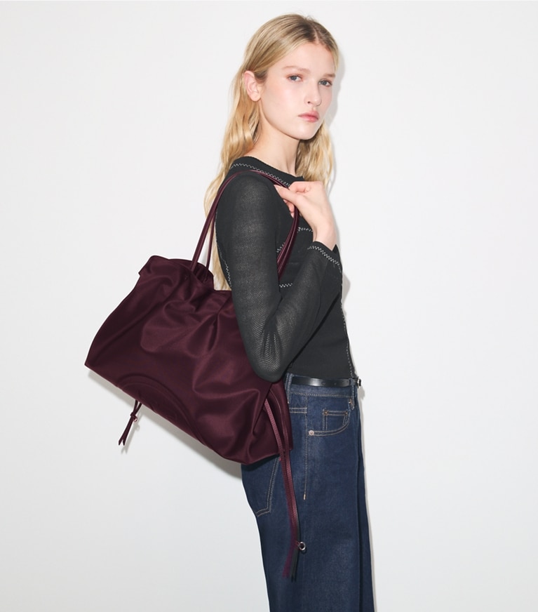 Tory Burch designer tote bags Ella Nylon Drawstring Tote in Dark Carmine accessory on model