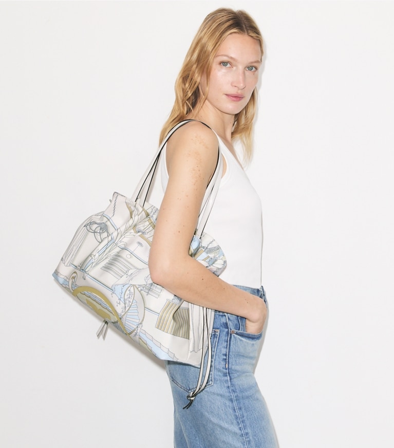 Tory Burch designer tote bags Ella Printed Drawstring Tote in The Pool Beige accessory on model