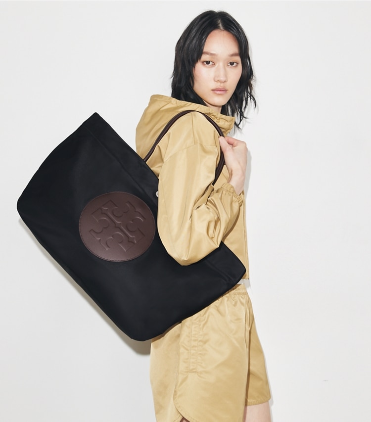 Tory Burch designer トートバッグ エラ ツイスト トートバッグ in Black accessory on model
