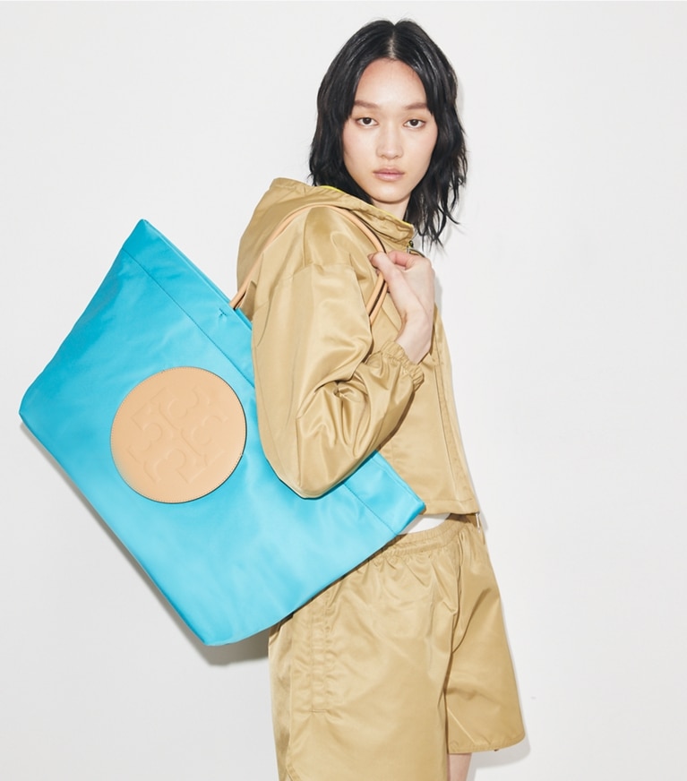 Tory Burch designer tote bags Ella Twist Reversible Tote in Soft Turquoise accessory on model