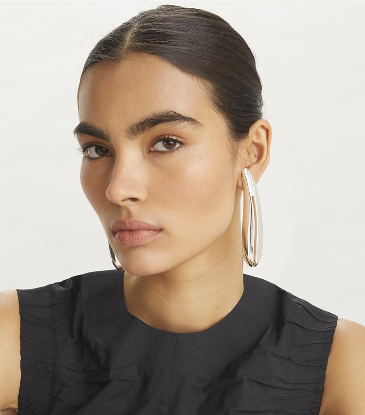Tory Burch designer earrings Elongated Wave Earrings in Light Silver accessory on model