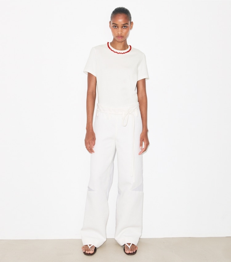 Tory Burch designer tops Embellished Cotton T-Shirt in Snow White / Bright Red on model front