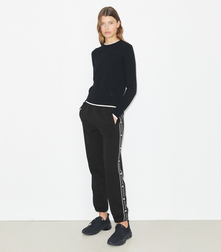 Tory Burch designer bottoms Embroidered French Terry Sweatpants in Black on model front