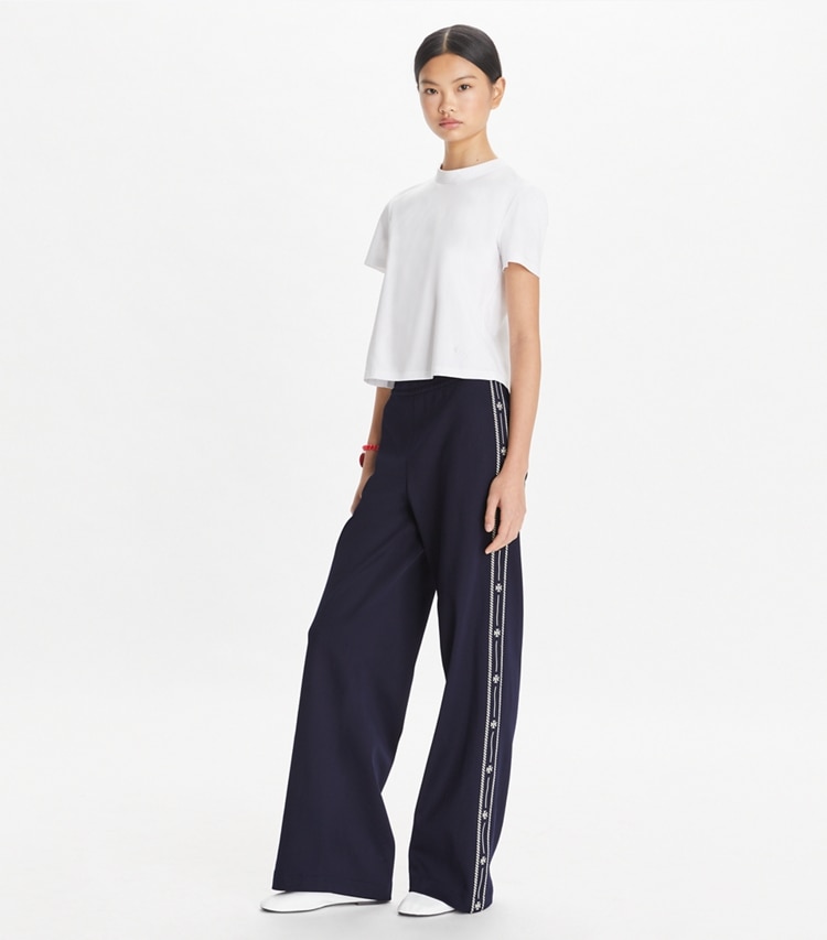 Tory Sport designer bottoms Embroidered Logo Nylon Track Pant in Deep Navy on model front