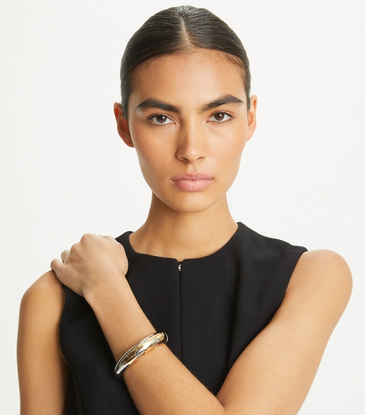 Tory Burch designer bracelets Essential Bangle in Tory Gold / Tory Silver accessory on model