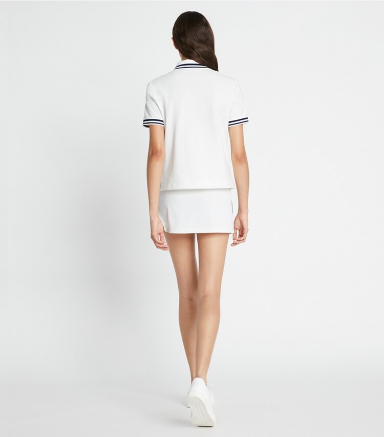 Tory Sport diseñador prendas inferiores Falda de tenis de piqué con franja de logotipo Tech en Snow White parte posterior en modelo