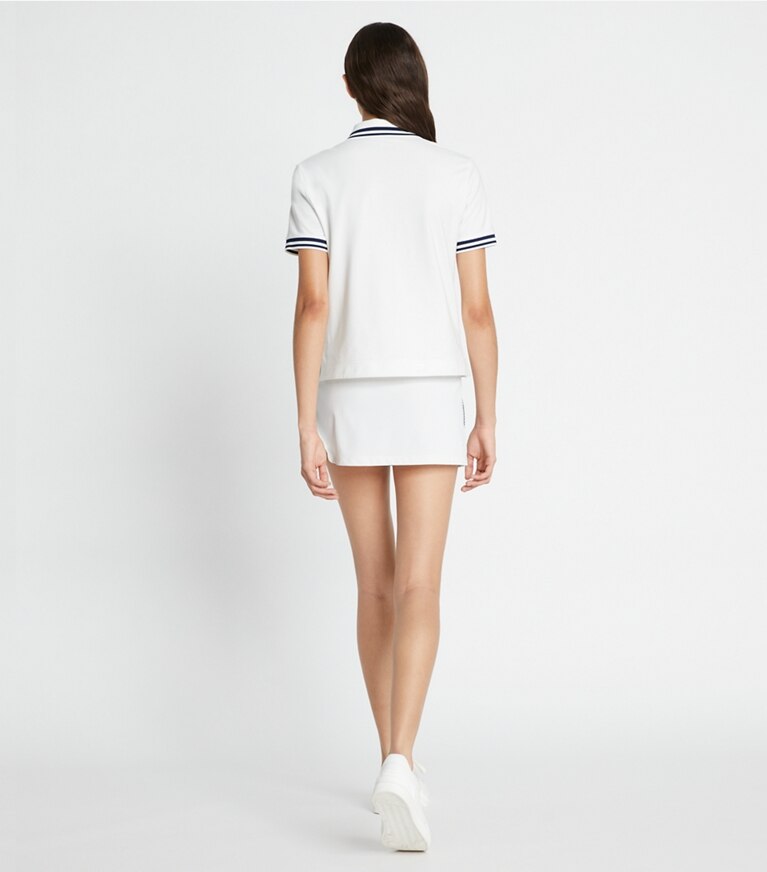 Tory Sport diseñador prendas inferiores Falda de tenis de piqué con franja de logotipo Tech en Snow White parte posterior en modelo