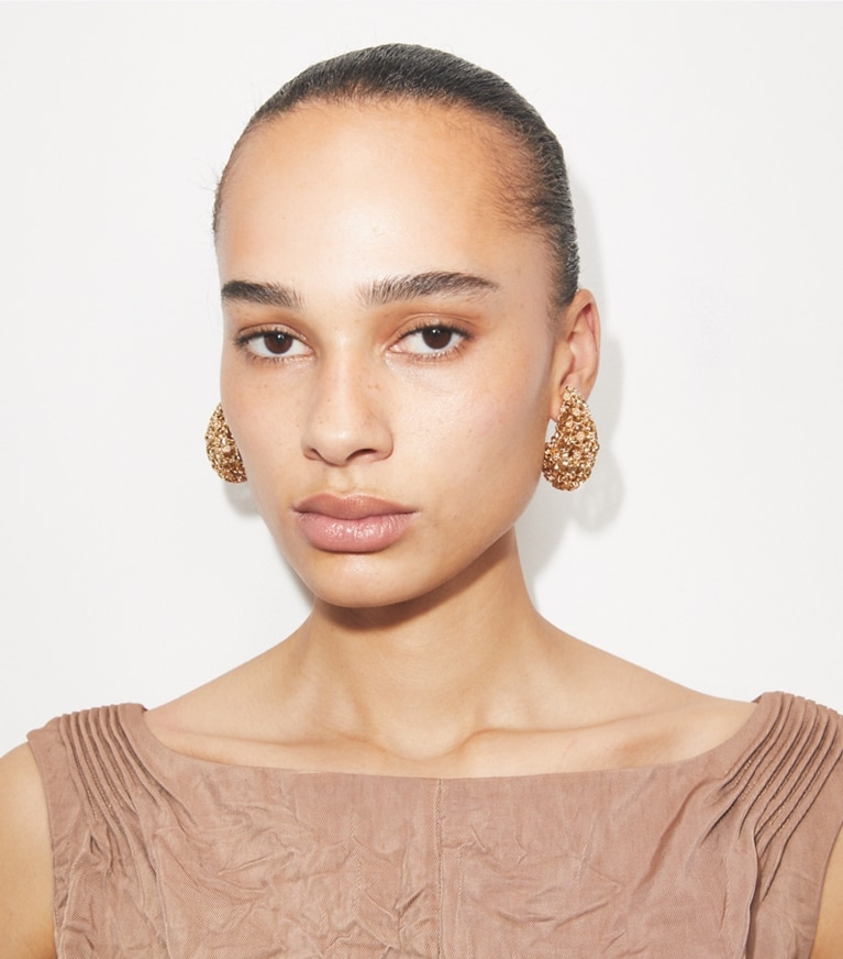 Tory Burch designer earrings Filigree Pierced Earrings in Tory Gold accessory on model