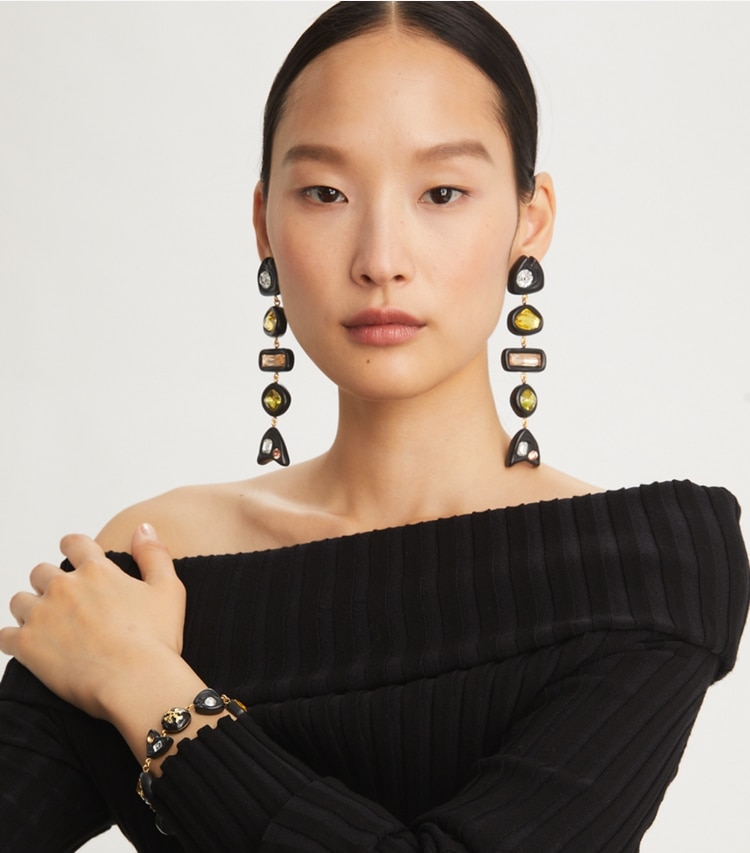 Tory Burch designer earrings Fish Crystal Earrings in Rolled Brass/Matte Black accessory on model