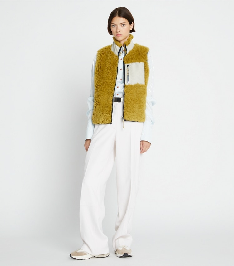 Tory Sport designer coats Fleece Zip Vest in Olive Grove on model front