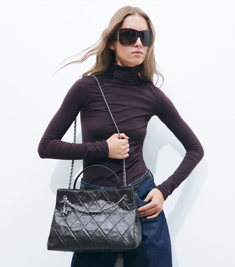 Tory Burch designer satchels Fleming Carryall in Cocoa accessory on model