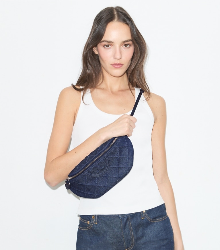 Tory Burch designer belt bags Fleming Denim Charm Belt Bag in Blue accessory on model
