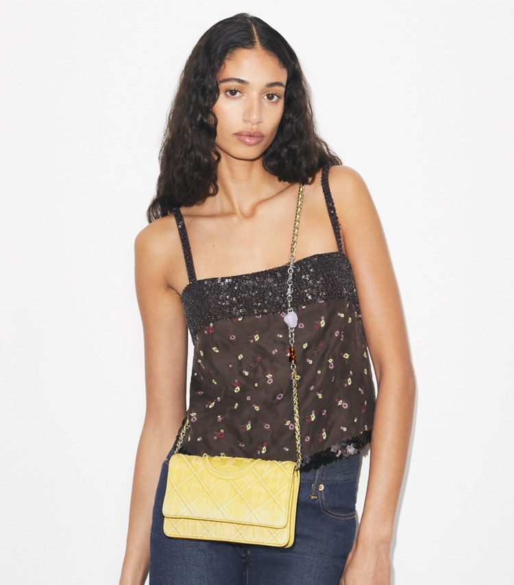 Tory Burch designer mini bags Fleming Denim Charm Chain Crossbody in Yellow accessory on model