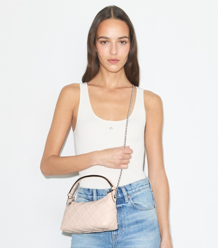 Tory Burch designer crossbody bags Fleming Distressed Pochette in Soft Pink accessory on model