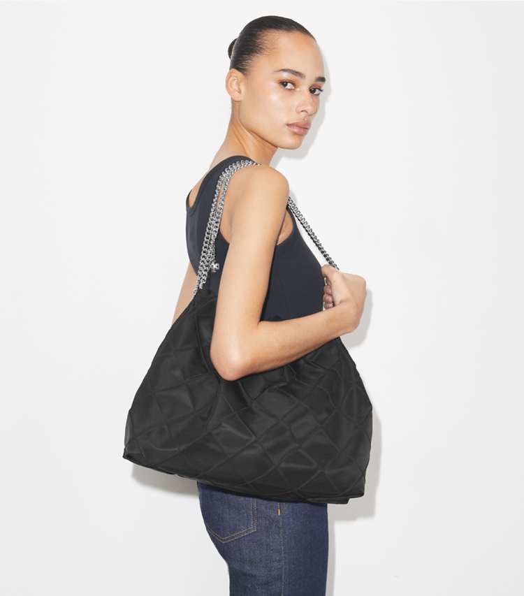 Tory Burch designer hobo bags Fleming Hobo Bag aus Nylon in Black accessory on model