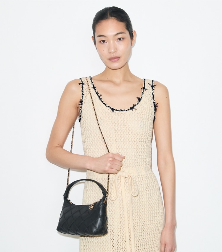Tory Burch designer crossbody bags Fleming Pochette in Black accessory on model