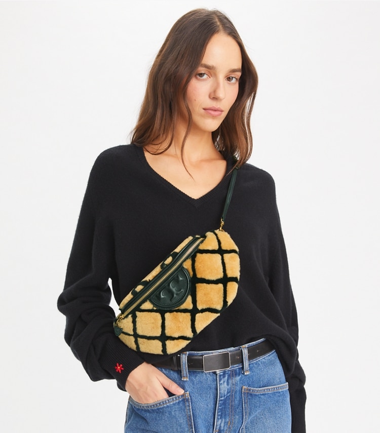 Tory Burch designer belt bags Fleming Shearling Convertible Belt Bag in Toffee accessory on model