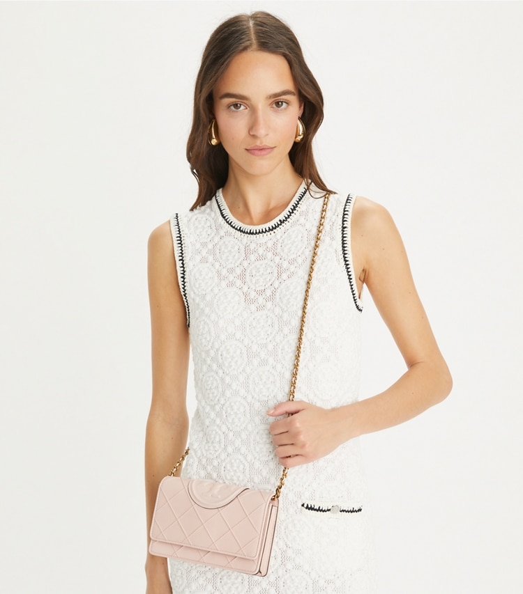 Tory Burch designer mini bags Fleming Soft Polished-Grain Crossbody in Pink Dawn accessory on model