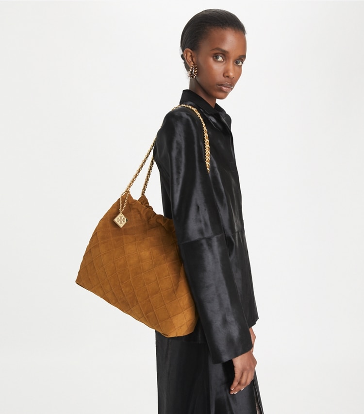 Tory Burch designer hobo bags Fleming Soft Suede Hobo Bag in Chicory Brown accessory on model