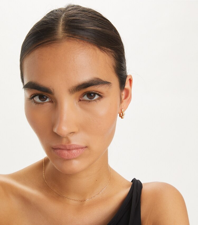Tory Burch designer earrings Flower Huggie Earring in Tory Gold accessory on model