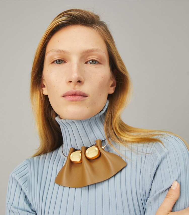 Tory Burch designer necklaces Fluted Leather Collar Necklace in Tory Gold / Brown accessory on model