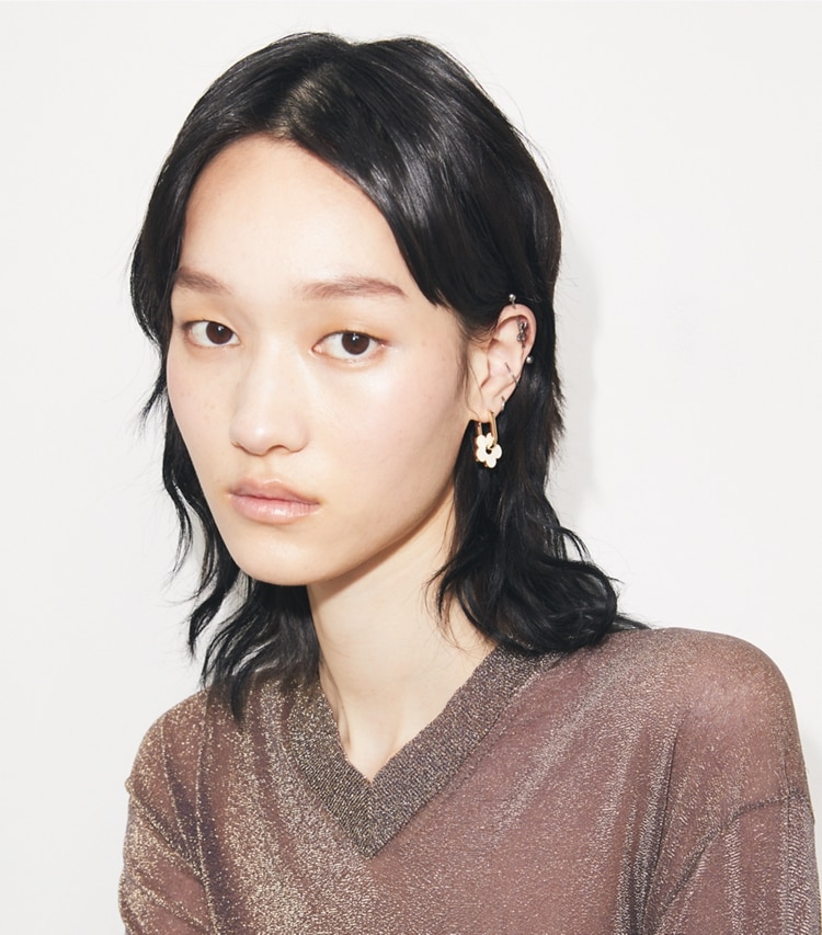 Tory Burch designer earrings Forget Me Not Charm Earrings in Tory Gold / Ivory accessory on model