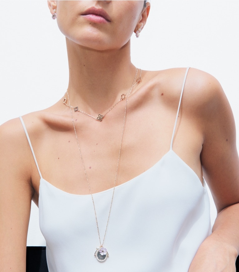 Tory Burch designer necklaces Forget Me Not Charm Pendant Necklace in Tory Gold / Pink / Cream accessory on model