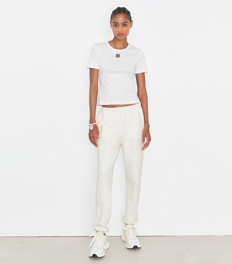 Tory Sport designer bottoms French Terry Cropped Sweatpant in Ivory White on model front