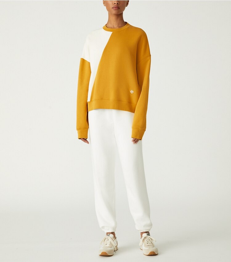 Tory Sport designer sweaters French Terry Diagonal Colorblock Crewneck in Spiced / Ivory Pearl on model front