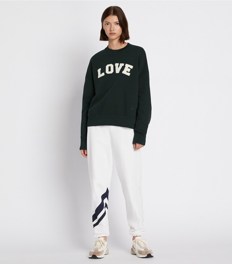 Tory Sport designer sweaters French Terry Varsity Crewneck in Conifer on model front
