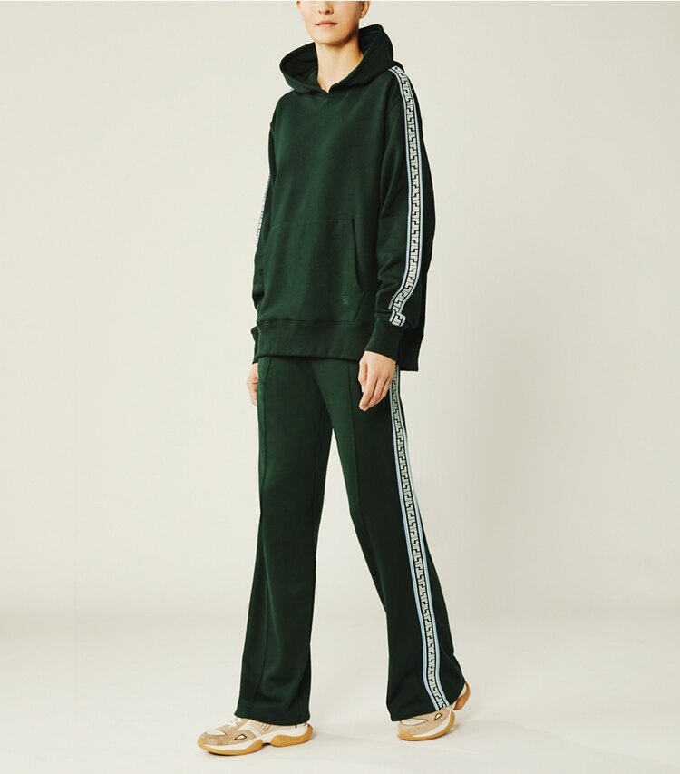 Tory Sport designer bottoms Geo-T Wide-Leg Track Pants in Conifer on model front