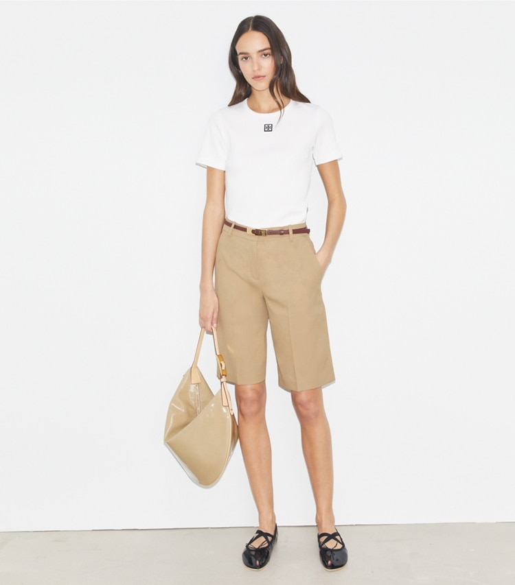 Tory Sport designer bottoms Golf Bermuda Short in Pale Teak on model front